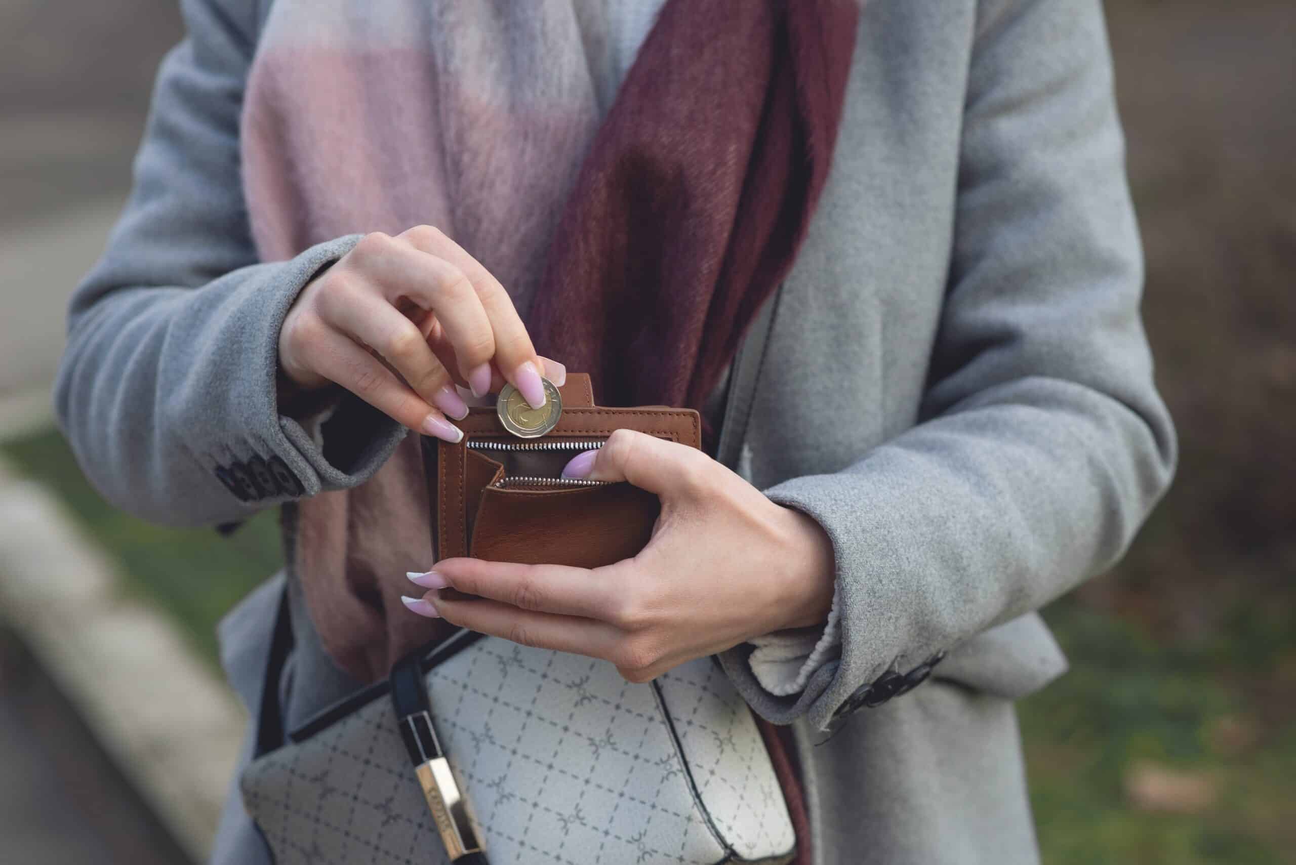 female-putting-money-in-wallet